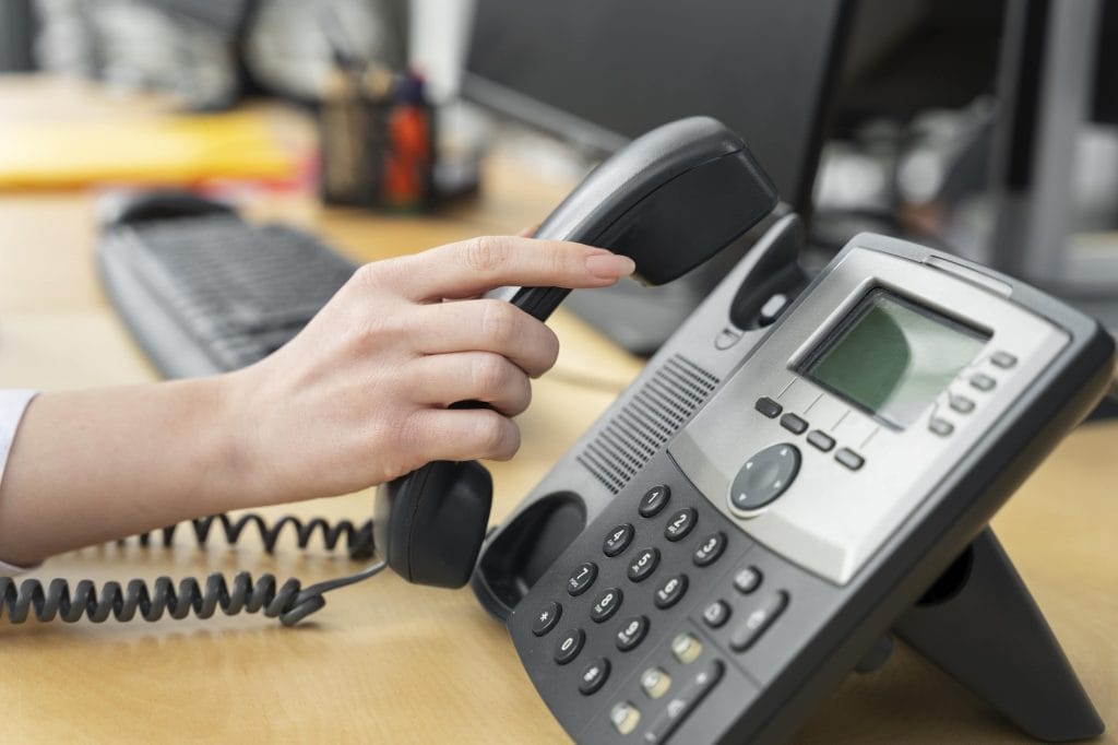 Woman putting phone down in office