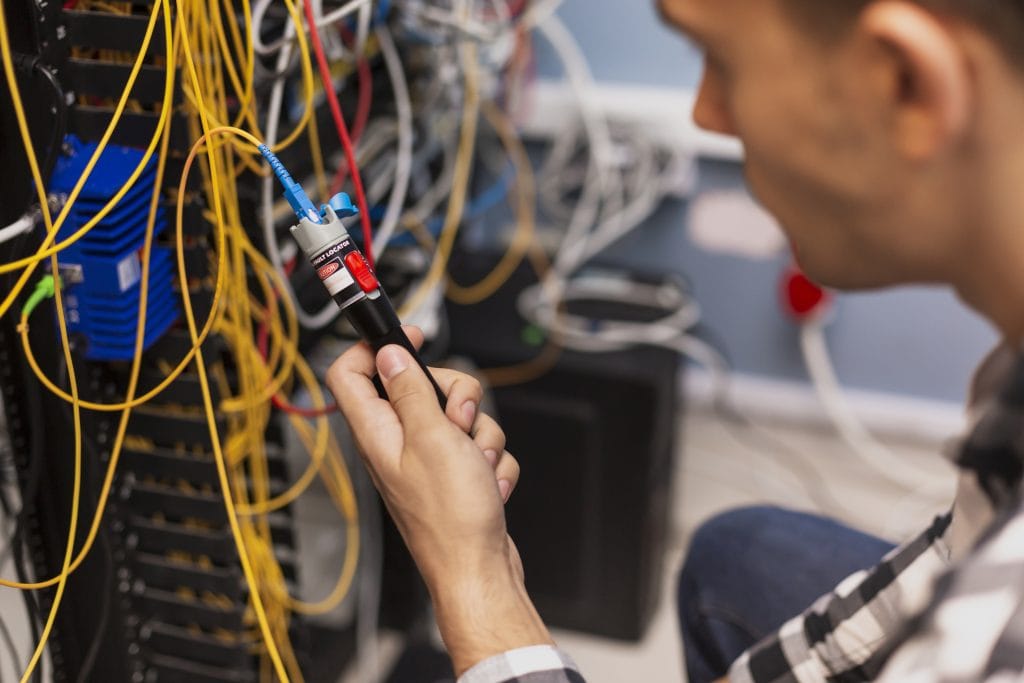 Man configuring fibre optics