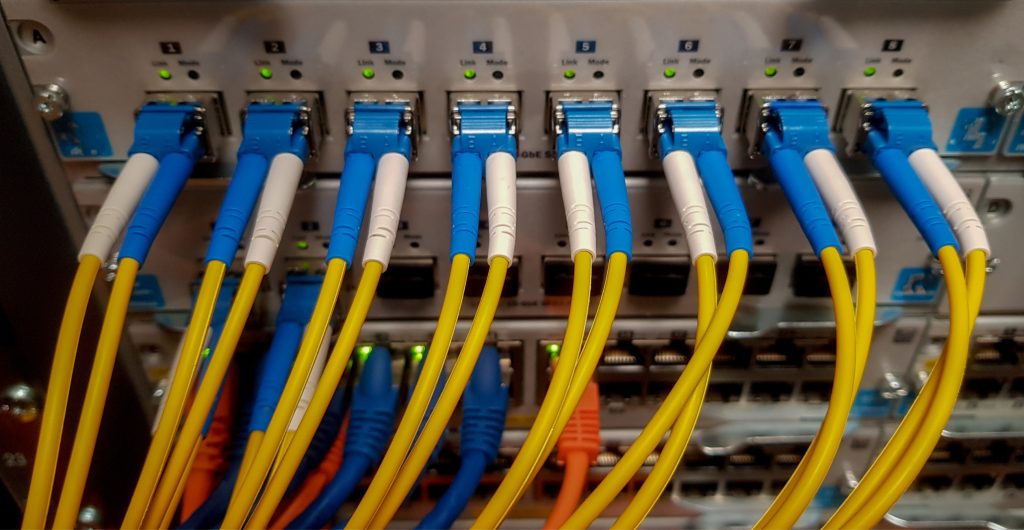 Fibre optic cables plugged into data network