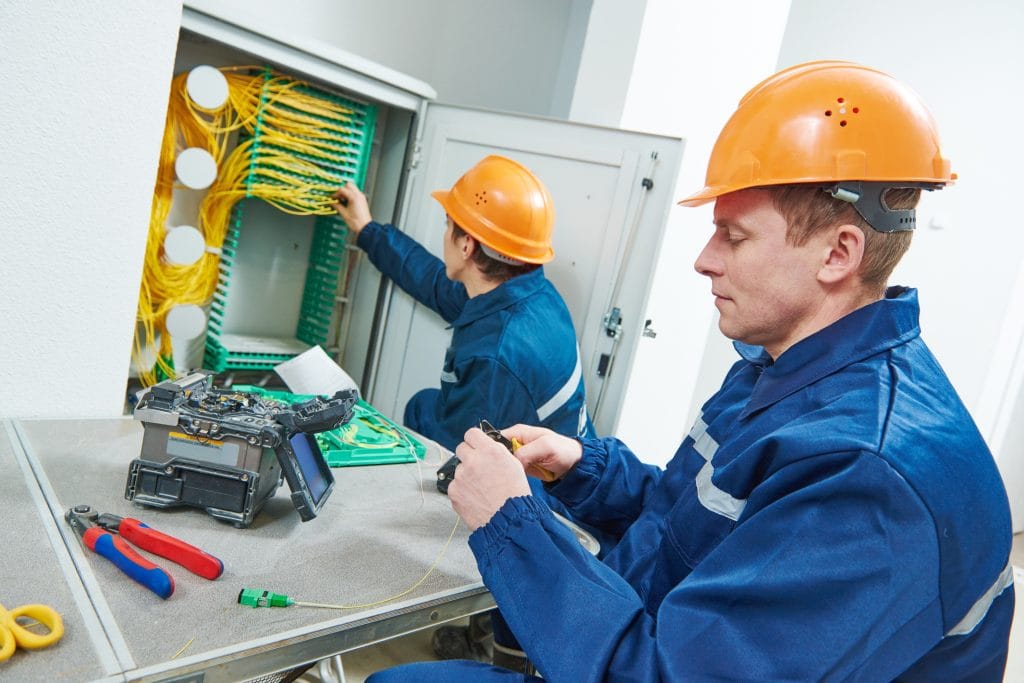 Engineers splicing fibre optic cables