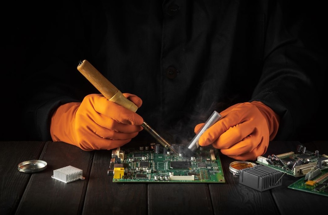 person working with electric circuit board