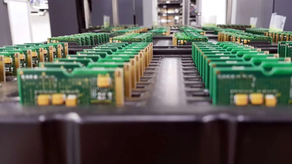 Rows of printed circuit boards on a high-volume PCB assembly production line.